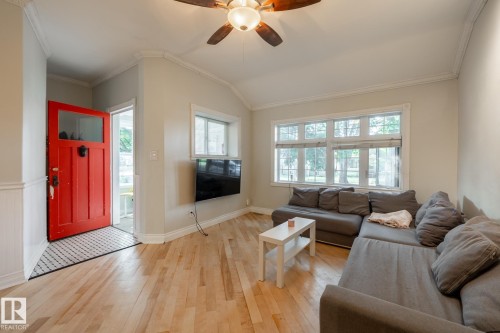 Living room with a ceiling fan, light wood-style flooring, lofted ceiling, and crown molding - 11415 85 Street, Edmonton, AB - Indoor Photo Showing Living Room