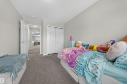 Carpeted bedroom featuring a closet and a textured ceiling - 