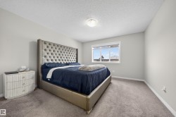 Bedroom with a textured ceiling and carpet - 