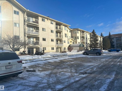 Snow covered building with a view of apartment building / complex and uncovered parking - 202 18020 95 Avenue, Edmonton, AB - Outdoor With Facade
