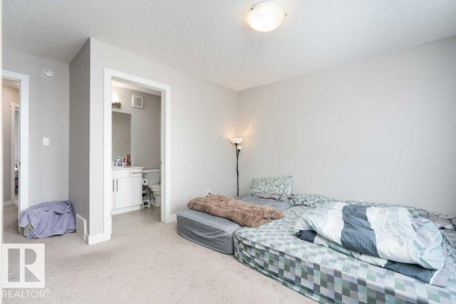 Living area featuring a textured ceiling and light carpet - 96 1530 Tamarack Boulevard, Edmonton, AB - Indoor Photo Showing Bedroom