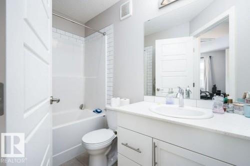 Full bathroom with vanity, a textured ceiling, and washtub / shower combination - 96 1530 Tamarack Boulevard, Edmonton, AB - Indoor Photo Showing Bathroom
