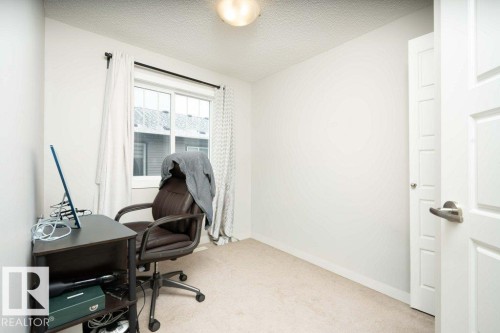 Office space featuring a textured ceiling and light carpet - 96 1530 Tamarack Boulevard, Edmonton, AB - Indoor Photo Showing Office