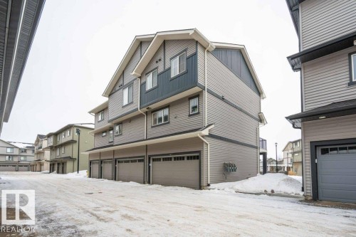 Snow covered back of property with a residential view - 96 1530 Tamarack Boulevard, Edmonton, AB - Outdoor With Exterior