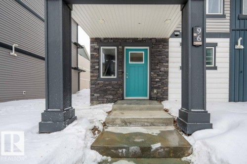 Snow covered property entrance with stone siding - 96 1530 Tamarack Boulevard, Edmonton, AB - Outdoor