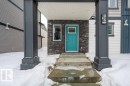 Snow covered property entrance with stone siding - 96 1530 Tamarack Boulevard, Edmonton, AB  - Outdoor 