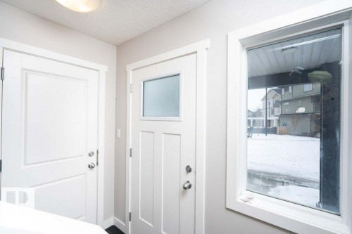 Doorway with a textured ceiling and baseboards - 96 1530 Tamarack Boulevard, Edmonton, AB - Indoor Photo Showing Other Room