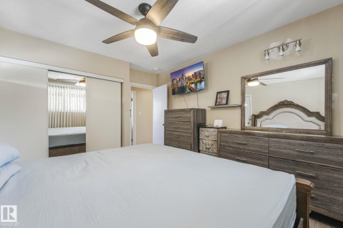 Bedroom with a ceiling fan and a closet - 2 Scarboro Place, St. Albert, AB - Indoor Photo Showing Bedroom