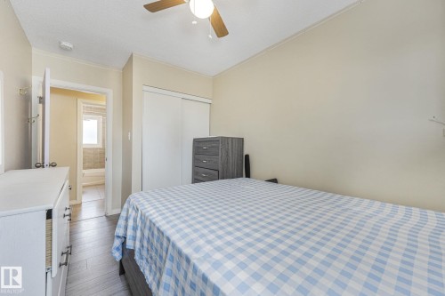 Bedroom with a closet, a ceiling fan, and wood finished floors - 2 Scarboro Place, St. Albert, AB - Indoor Photo Showing Bedroom