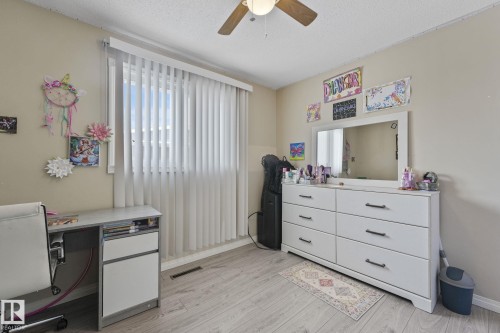 Office space with a ceiling fan, light wood-type flooring, and a textured ceiling - 2 Scarboro Place, St. Albert, AB - Indoor