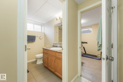 Bathroom featuring vanity and light tile patterned floors - 2 Scarboro Place, St. Albert, AB - Indoor Photo Showing Bathroom