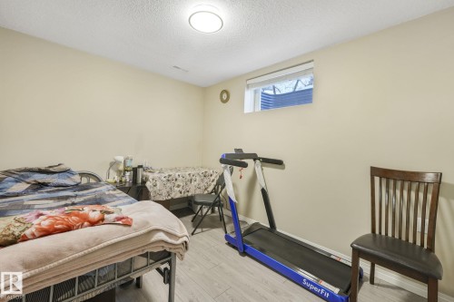 Bedroom featuring light wood-style floors and a textured ceiling - 2 Scarboro Place, St. Albert, AB - Indoor Photo Showing Gym Room