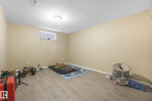 Interior space featuring light wood-style floors and a textured ceiling - 2 Scarboro Place, St. Albert, AB - Indoor