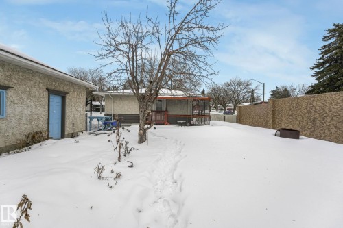 Yard layered in snow with a wooden deck - 2 Scarboro Place, St. Albert, AB - Outdoor