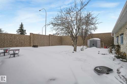 Snowy yard featuring a storage shed and a fenced backyard - 2 Scarboro Place, St. Albert, AB - Outdoor
