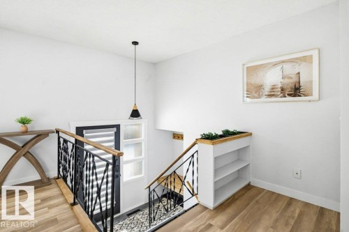 Stairs with wood finished floors and baseboards - 7016 92A Avenue, Edmonton, AB - Indoor Photo Showing Other Room