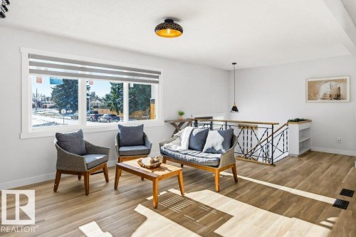 Living area featuring an upstairs landing and light wood-type flooring - 7016 92A Avenue, Edmonton, AB - Indoor Photo Showing Other Room