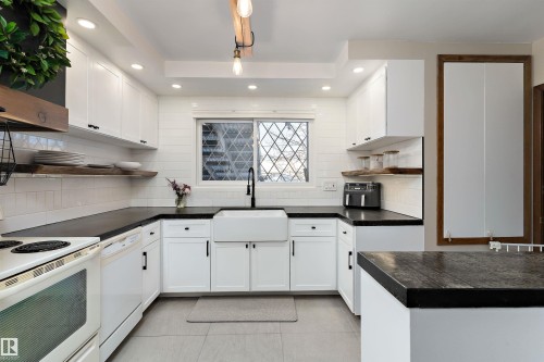 Kitchen featuring white cabinets, white appliances, dark countertops, recessed lighting, and tasteful backsplash - 7316 100 Avenue, Edmonton, AB - Indoor Photo Showing Kitchen