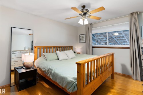 Bedroom with wood finished floors and a ceiling fan - 7316 100 Avenue, Edmonton, AB - Indoor Photo Showing Bedroom