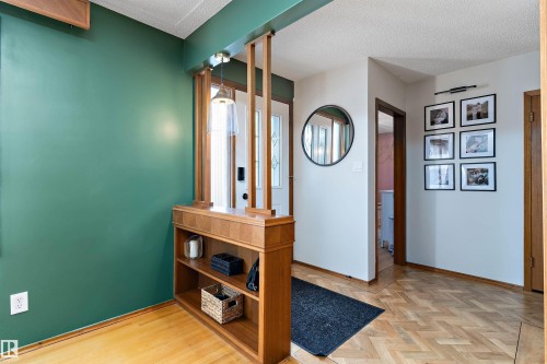 Hall featuring parquet floors and a textured ceiling - 7316 100 Avenue, Edmonton, AB - Indoor Photo Showing Other Room