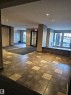 Common area with a textured ceiling and recessed lighting - 413 5521 7 Avenue, Edmonton, AB  - Indoor Photo Showing Other Room 