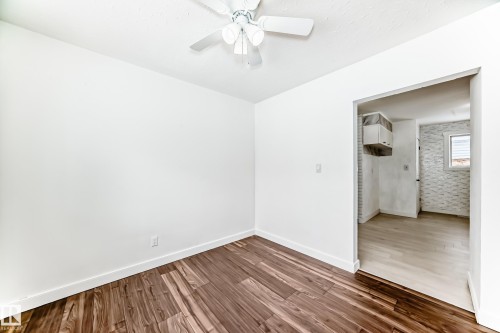 Unfurnished room with wood finished floors and ceiling fan - 13904 135 Avenue, Edmonton, AB - Indoor Photo Showing Other Room