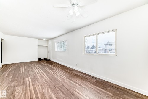 Empty room with a ceiling fan and light wood-style floors - 13904 135 Avenue, Edmonton, AB - Indoor Photo Showing Other Room
