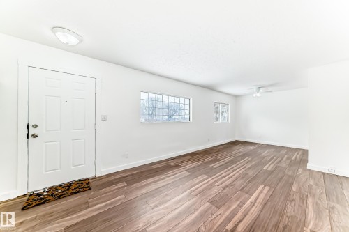 Entrance foyer featuring light wood-style flooring and a ceiling fan - 13904 135 Avenue, Edmonton, AB - Indoor Photo Showing Other Room