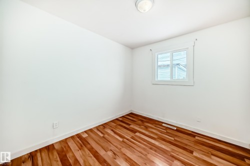 Spare room featuring light wood-style floors and baseboards - 13904 135 Avenue, Edmonton, AB - Indoor Photo Showing Other Room