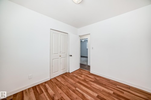 Unfurnished bedroom featuring light wood-type flooring and a closet - 13904 135 Avenue, Edmonton, AB - Indoor Photo Showing Other Room