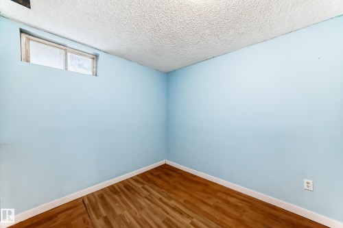 Unfurnished room with a textured ceiling and wood finished floors - 13904 135 Avenue, Edmonton, AB - Indoor Photo Showing Other Room