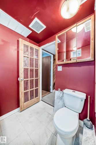 Bathroom featuring toilet and baseboards - 13904 135 Avenue, Edmonton, AB - Indoor Photo Showing Bathroom