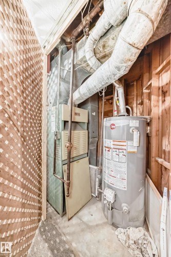 Utility room featuring gas water heater and heating unit - 13904 135 Avenue, Edmonton, AB - Indoor Photo Showing Basement