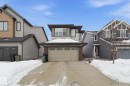 View of front facade with brick siding, an attached garage, and concrete driveway - 3234 Chernowski Way, Edmonton, AB  - Outdoor With Facade 