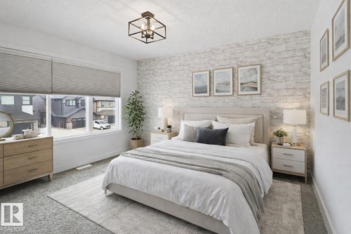 Bedroom with an accent wall, carpet, and a textured ceiling - 3234 Chernowski Way, Edmonton, AB - Indoor Photo Showing Bedroom
