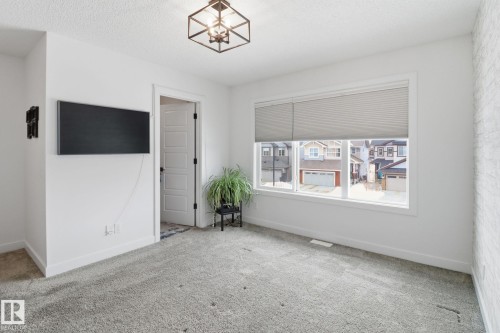 Spare room featuring carpet floors and a textured ceiling - 3234 Chernowski Way, Edmonton, AB - Indoor Photo Showing Other Room