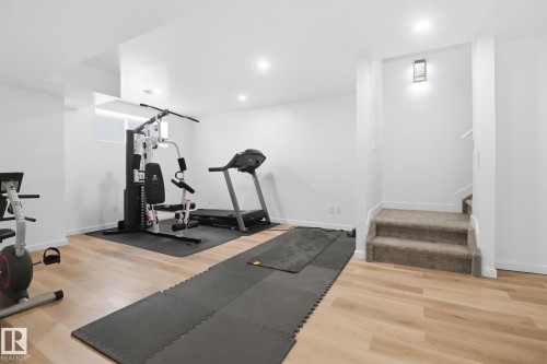 Workout room featuring light wood finished floors and recessed lighting - 3234 Chernowski Way, Edmonton, AB - Indoor Photo Showing Gym Room