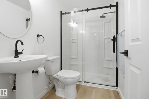 Bathroom featuring a stall shower and light wood finished floors - 3234 Chernowski Way, Edmonton, AB - Indoor Photo Showing Bathroom