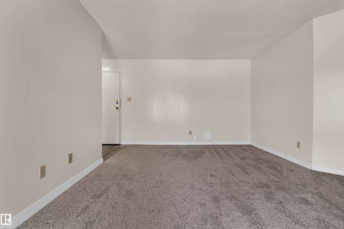 Unfurnished room featuring carpet flooring and a textured ceiling - 25 11255 31 Avenue, Edmonton, AB - Indoor Photo Showing Other Room