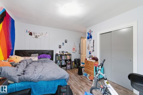 Bedroom featuring light wood-style floors and a closet - 13538 127 Street, Edmonton, AB - Indoor Photo Showing Bedroom