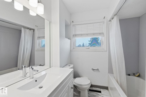 Full bathroom featuring vanity, healthy amount of natural light, and shower / bath combo with shower curtain - 13538 127 Street, Edmonton, AB - Indoor Photo Showing Bathroom