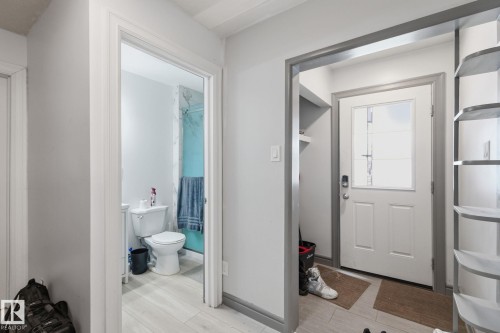 Entrance foyer with baseboards and light wood-style flooring - 13538 127 Street, Edmonton, AB - Indoor Photo Showing Bathroom