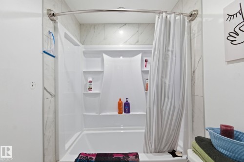 Bathroom with toilet and shower / bath combination with curtain - 13538 127 Street, Edmonton, AB - Indoor Photo Showing Bathroom