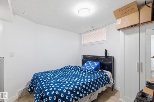 Bedroom with light wood-style flooring and a textured ceiling - 13538 127 Street, Edmonton, AB - Indoor Photo Showing Bedroom