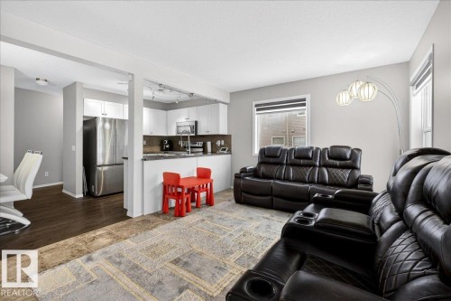 Living area with track lighting and a textured ceiling - 47 230 Edwards Drive, Edmonton, AB - Indoor Photo Showing Living Room