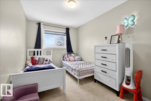 Bedroom featuring carpet and a textured ceiling - 47 230 Edwards Drive, Edmonton, AB - Indoor Photo Showing Bedroom