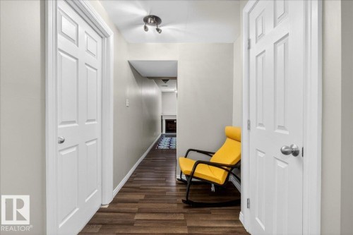 Hallway with dark wood-style floors and baseboards - 47 230 Edwards Drive, Edmonton, AB - Indoor Photo Showing Other Room