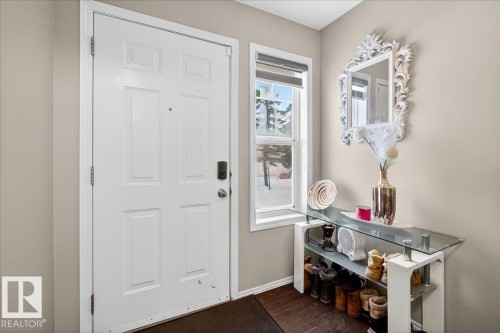 Foyer with dark wood-style flooring and baseboards - 47 230 Edwards Drive, Edmonton, AB - Indoor Photo Showing Other Room