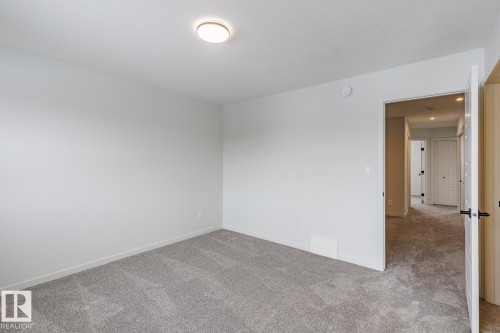 Unfurnished room with carpet flooring and baseboards - 75 Dansereau Way, Beaumont, AB - Indoor Photo Showing Other Room