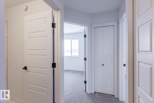Hallway with light carpet and baseboards - 75 Dansereau Way, Beaumont, AB - Indoor Photo Showing Other Room